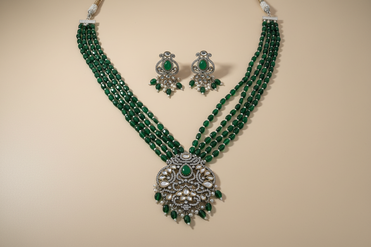 Green beaded necklace with silver and green accessories on a beige background