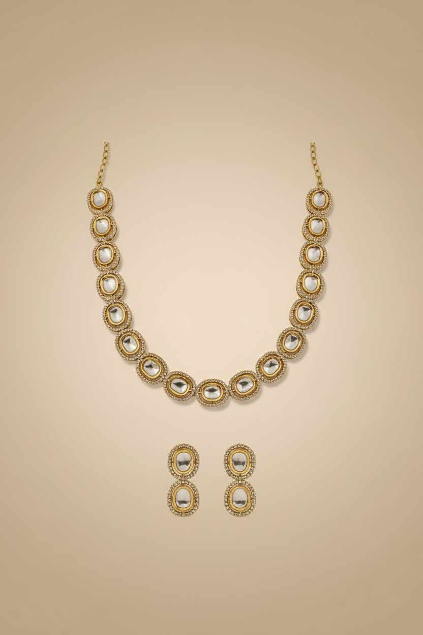Gold necklace and earrings set on a beige background
