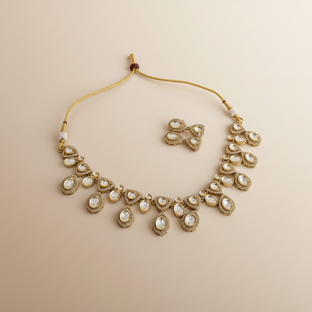 Gold necklace with white stones on a beige background